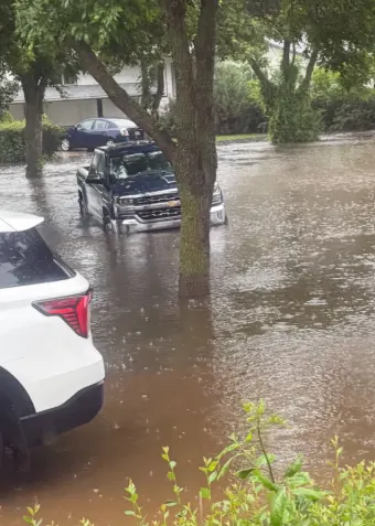 CBC: Flooded streets and submerged vehicles in Canora, Sask., after a weekend of heavy rain. (Submitted by Brandi Zavislak)