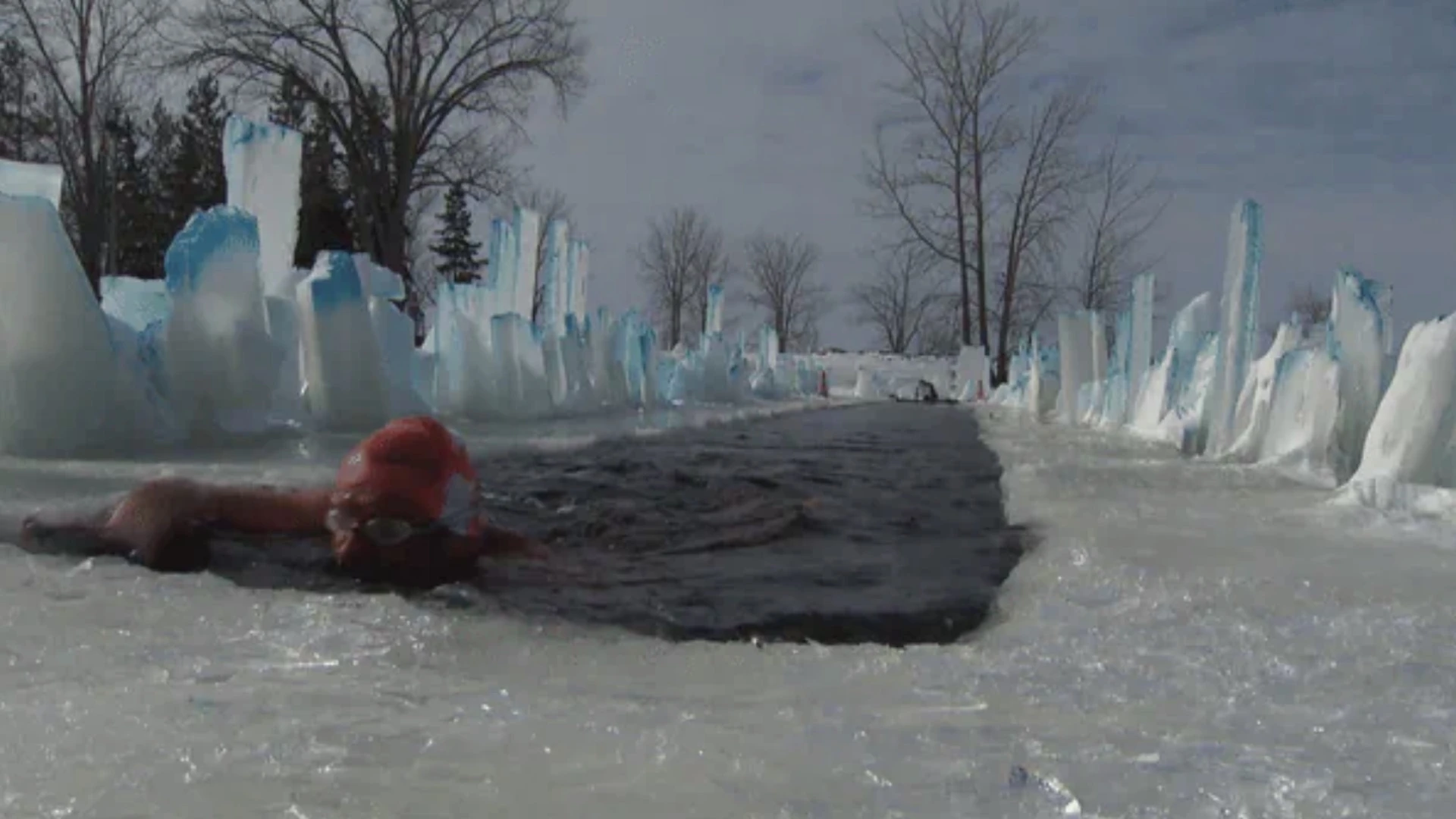 Swimmer stays in a lane he's carved in the frozen Ottawa River