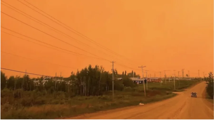 The sky was orange over Pukatawagan on Thursday in this photo posted to the Thompson Professional Firefighters Association's Facebook page. (Thompson Professional Firefighters Association/Facebook)