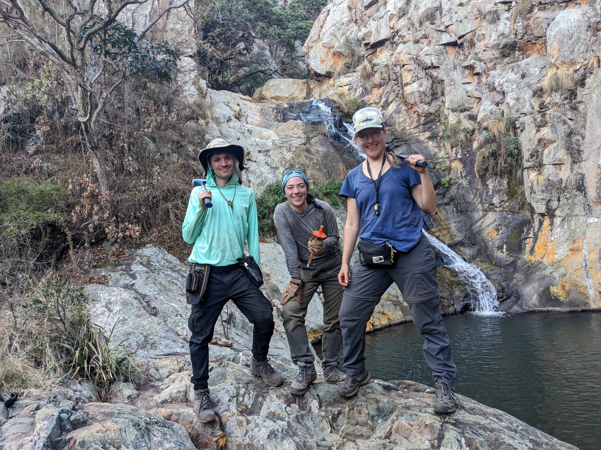REUTERS: Harvard University geologist Nadja Drabon poses with students David Madrigal Trejo and Oyuku Mete during fieldwork in a region called the Barberton Greenstone Belt in northeastern South Africa in this undated photograph. The region bears evidence of a huge meteorite impact on Earth dating back to about 3.26 billion years ago. Nadja Drabon/Handout via REUTERS