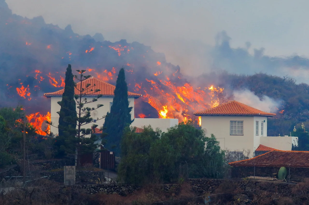 Canaries volcano streams slow down, homes destroyed, thousands flee