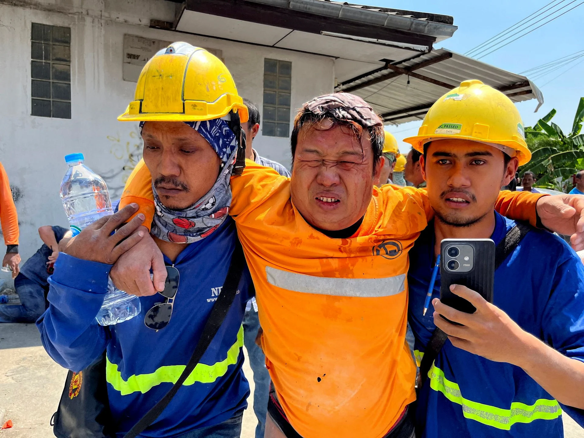 Reuters: Workers assist an injured man after a strong earthquake struck central Myanmar on Friday, earthquake monitoring services said, which affected Bangkok as well with people pouring out of buildings following the tremors in the Thai capital, in Bangkok, Thailand, March 28, 2025. REUTERS/Ann Wang