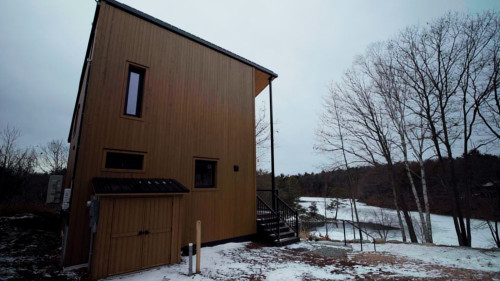 Canadian winter home designed by Atelier L'Abri looks like it is covered in  snow in the forest