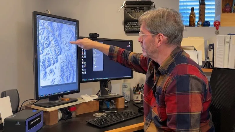CBC Clark merges public domain and satellite information into three different applications to process the data and start creating his maps. (Alanna Kelly/CBC)