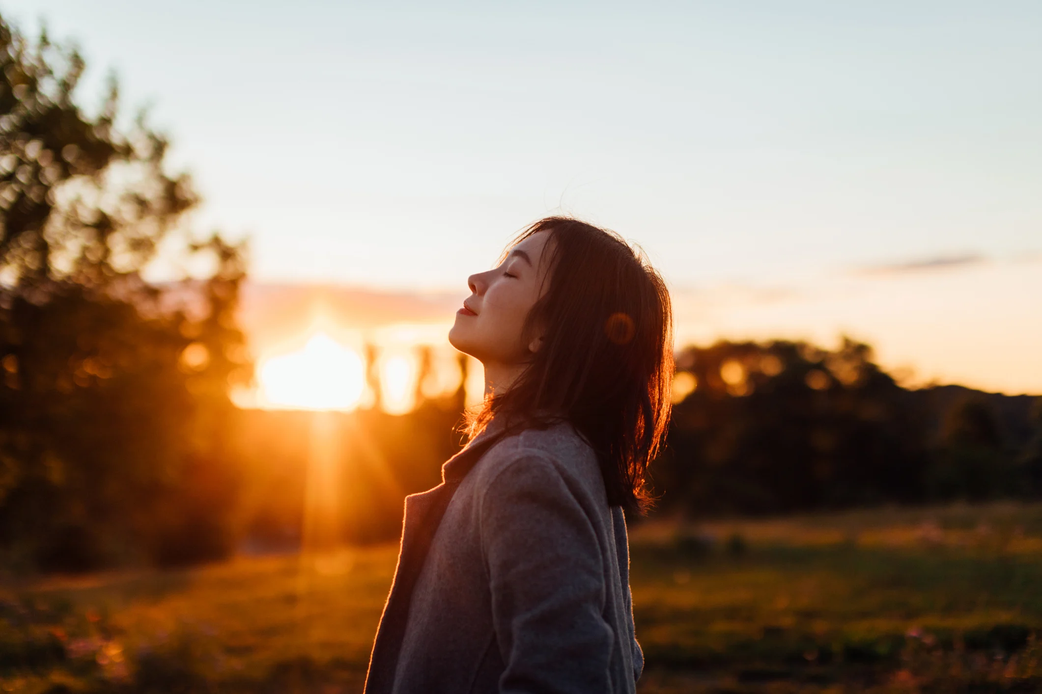 woman sunset (Oscar Wong. Moment. Getty Images)