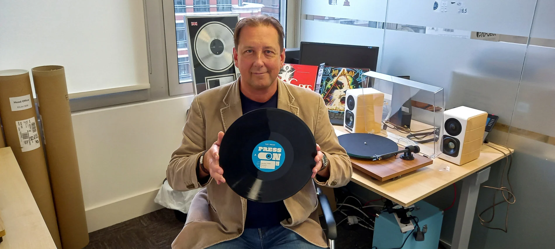 Marc Carey, CEO of Evolution Music, holds a bioplastic record made with a sugar-based alternative to vinyl, in London, Britain September 8, 2022. (REUTERS/Stuart McDill)