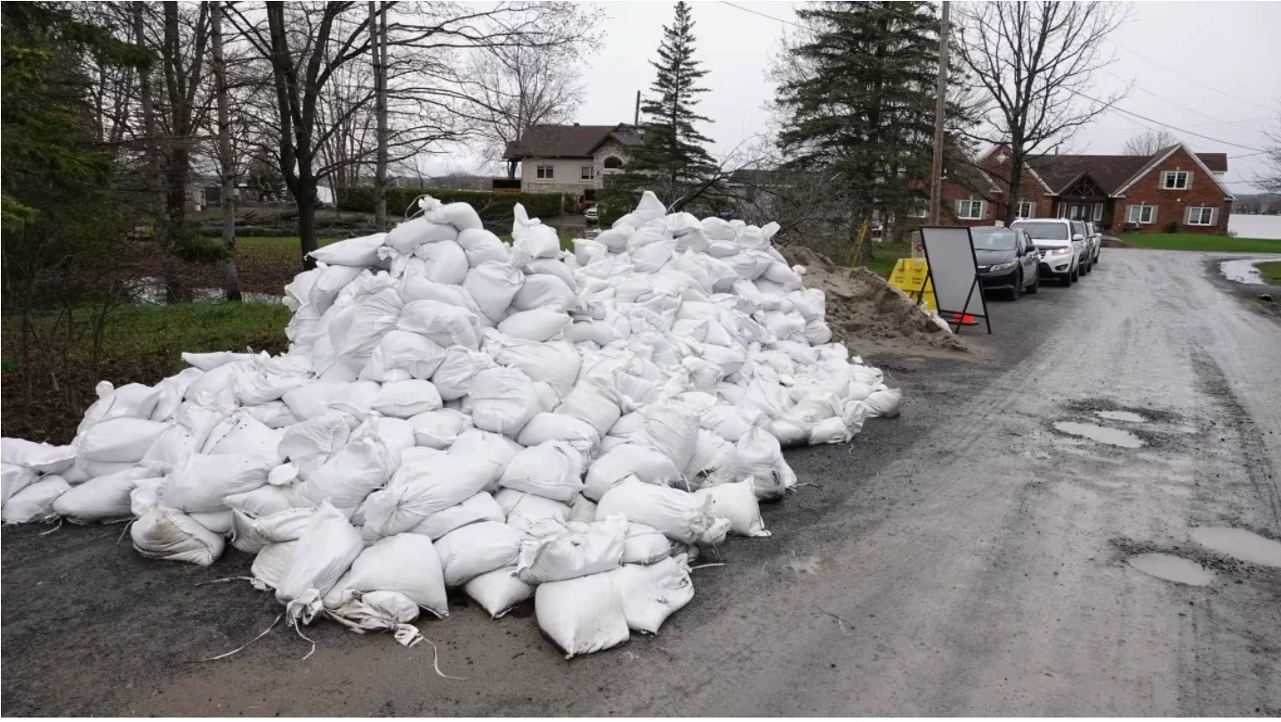 CBC: A pile of sandbags sits on East Shore Road in Cumberland, awaiting use to hold back rising water levels. (Giacomo Panico/CBC)