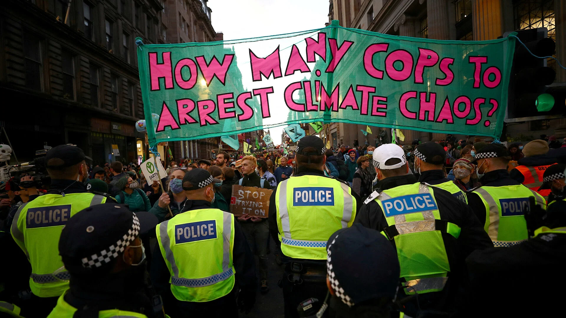 Extinction Rebellion activists stand in front of police officers as they protest during the UN Climate Change Conference (COP26) in Glasgow, Scotland, Britain, November 3, 2021 REUTERS/Hannah McKay/File Photo