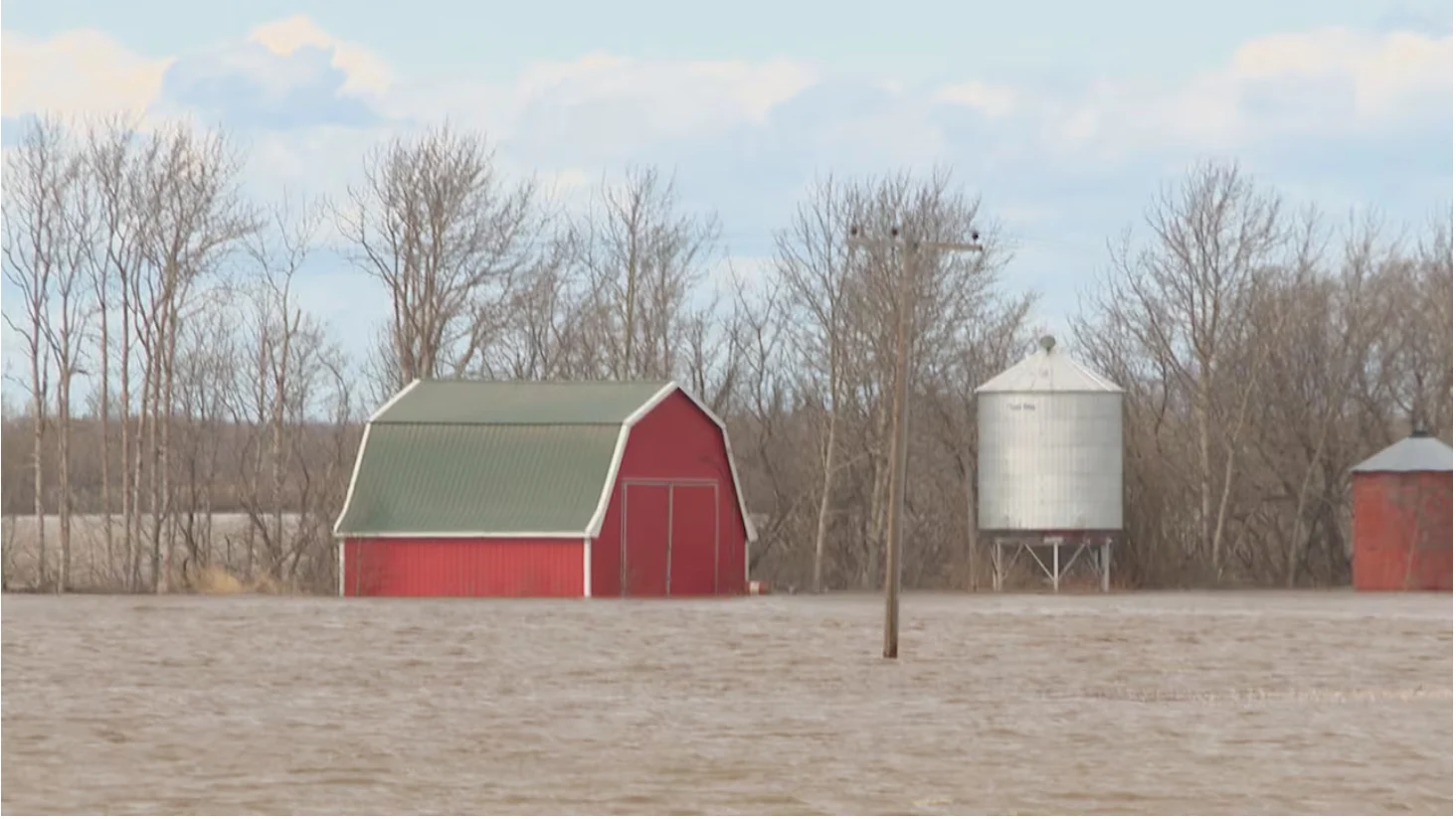 CBC: A barn sits in a flooded yard on Sunday in the Tisdale area. (Thomas Simon/CBC)