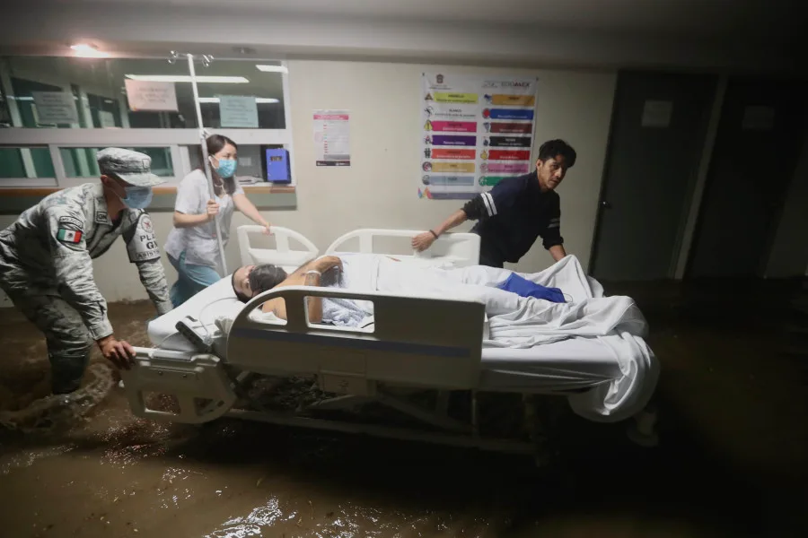 Reuters: Employees of the hospital of Atizapan, in the zone Metropolitana del Valle de Mexico north of Mexico City, transport a patient after the hospital was flooded by extreme rainfall with hail. Some of the patients were moved to higher floors, but some still had to stay in the water.