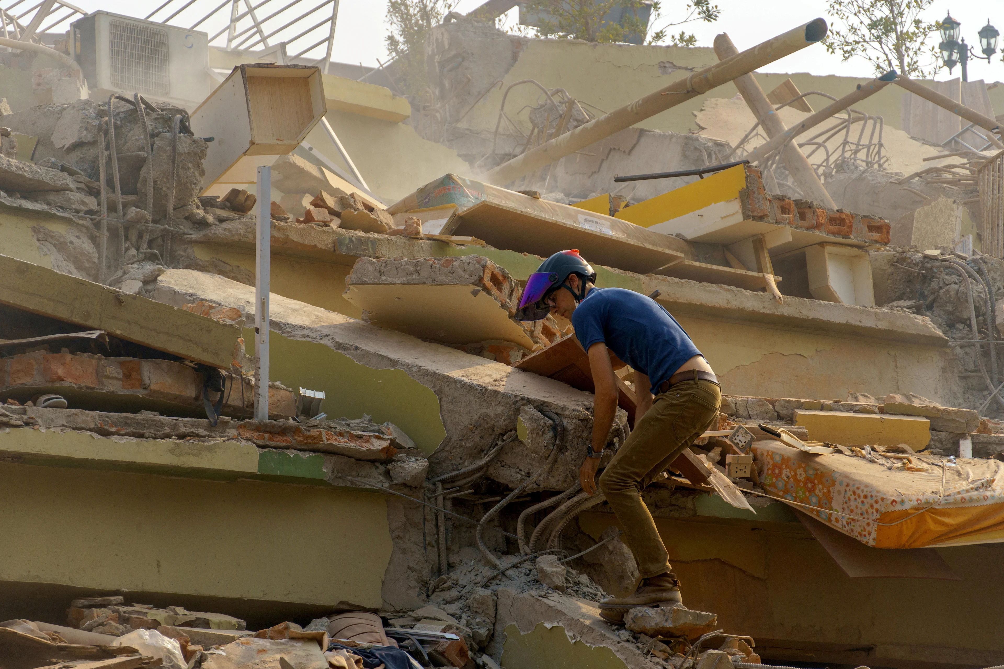 REUTERS: A man walks the rubble of the building that collapsed following a strong earthquake, in Mandalay, Myanmar, March 29, 2025.