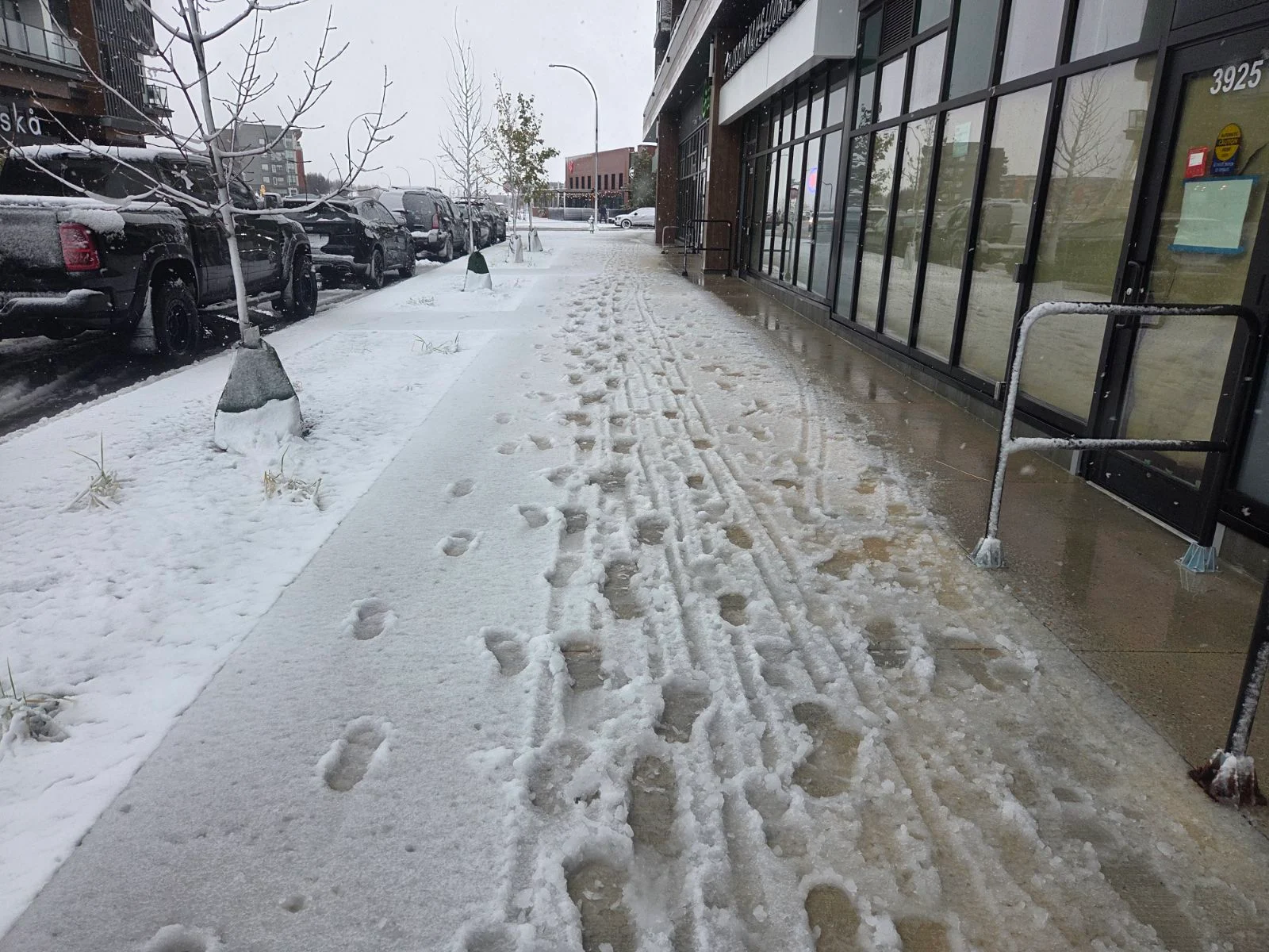 A snowy sidewalk in Calgary, Alta., on Oct. 23, 2026. (Connor O'Donovan/TWN)
