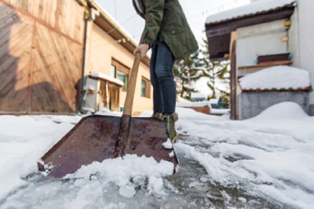 getty woman shoveling snow