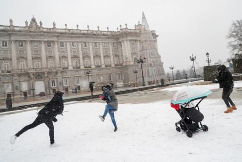 REUTERS: FILE PHOTO: People have a snowball fight outside the Royal Palace during a snowfall in Madrid, Spain January 7, 2021. REUTERS/Susana Vera/File Photo