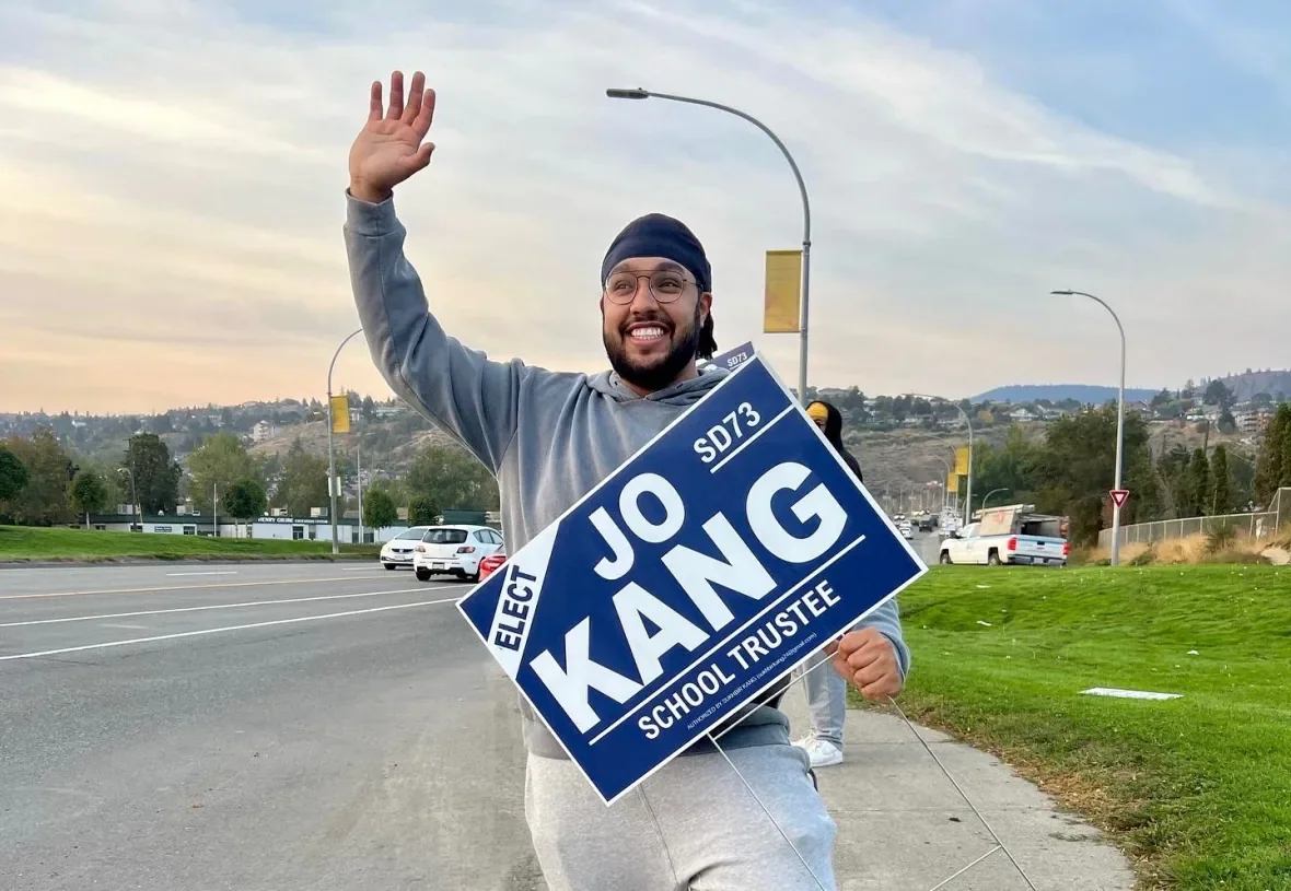 sd73-trustee-jo-kang-holds-his-election-sign/Submitted by Jo Kang via CBC