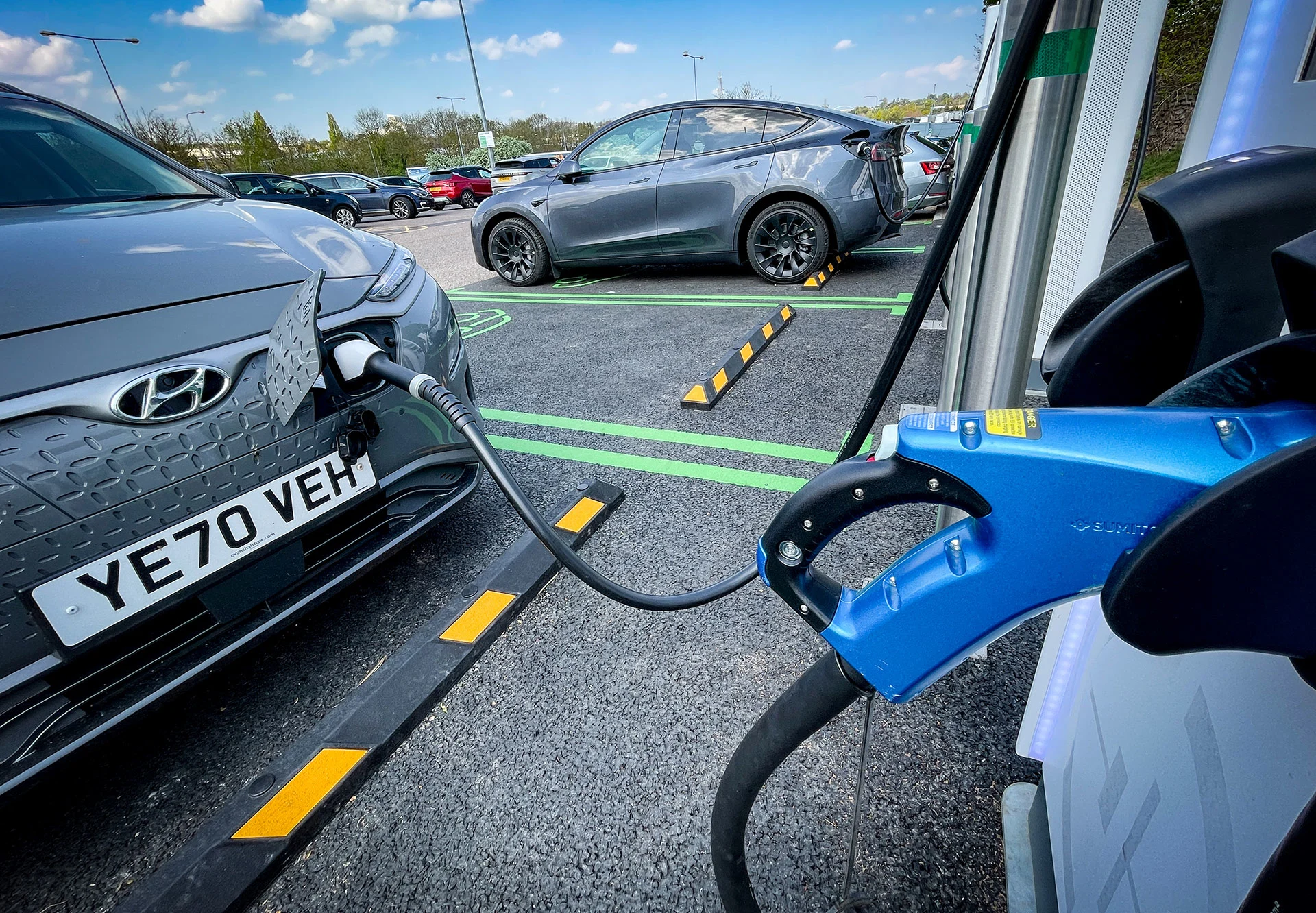 Electric cars at a motorway service station are charged by a bank of electrical chargers on April 24, 2022 in Exeter, England. The government's commitment to reducing future Co2 carbon emissions will mean many more motorists will need to switch from petrol and diesel-powered cars to electric (EV) driven ones. However there are fears that the charging network in the UK is not yet fit to deal with the enormous demand more EVs on the road would place on it. (Matt Cardy/ Getty Images)