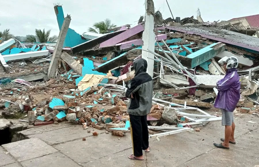 REUTERS: People look at a damaged hospital building following an earthquake in Mamuju, West Sulawesi province, Indonesia, January 15, 2021 in this photo taken by Antara Foto. Antara Foto/Akbar Tado via REUTERS