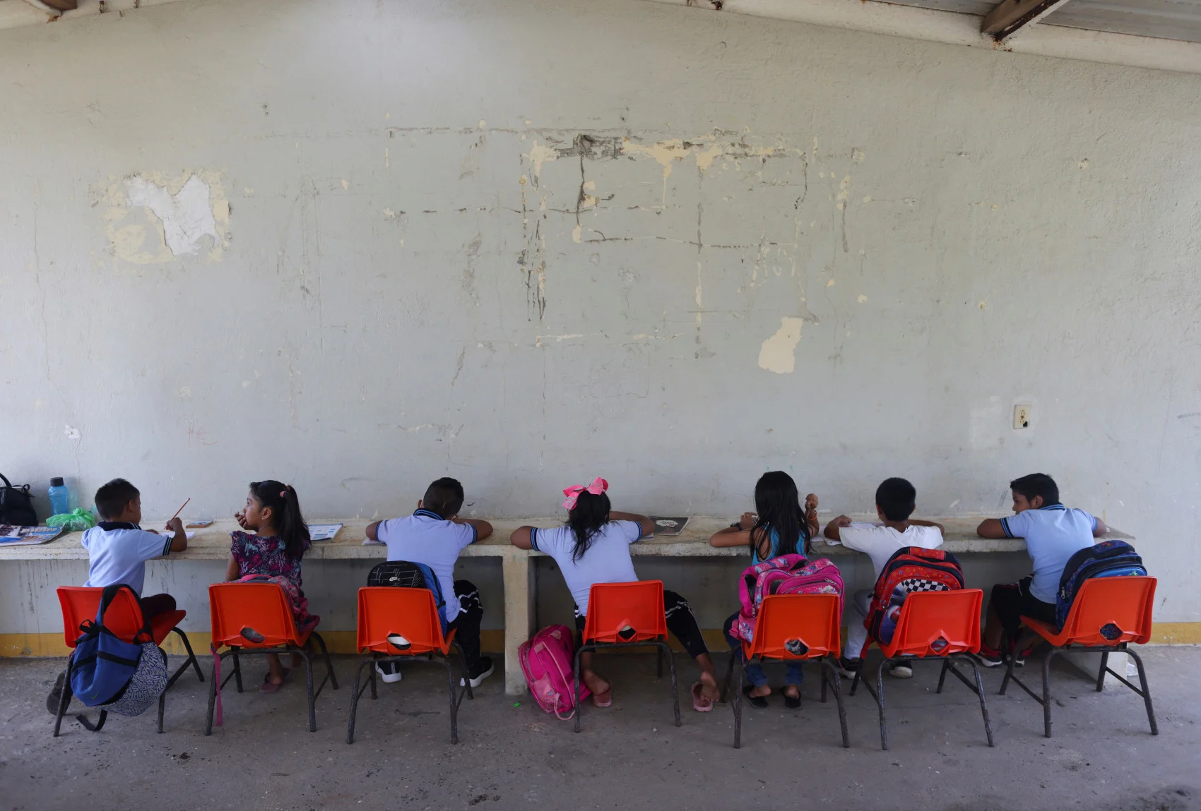 Children attend school outside the school building as their classrooms have been affected by rising sea levels, in El Bosque, Mexico November 7, 2022. (REUTERS/Gustavo Graf)