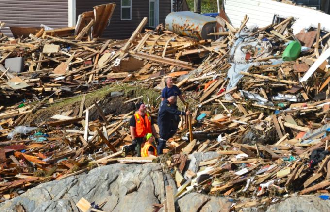 First responders searched through the rubble, with one telling CBC News they were looking for a missing woman who had been swept out to sea during the storm. (Malone Mullin/CBC)