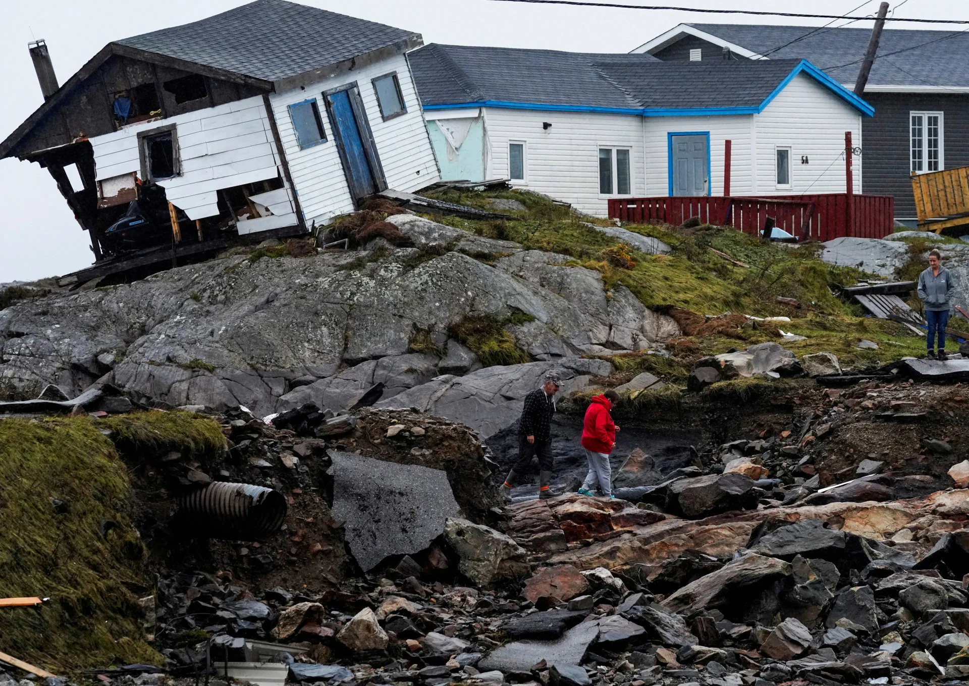 REUTERS: FILE PHOTO: Persons head to their homes in the aftermath of Hurricane Fiona in Burnt Islands, Newfoundland, Canada September 27, 2022. REUTERS/John Morris/File Photo