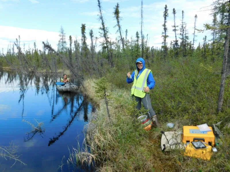 Researchers McKenzie Kuhn and Trisha Elliot measure methane emissions from a pond that is expanding due to permafrost thaw near Fort McPherson N.W.T. (David Olefeldt)