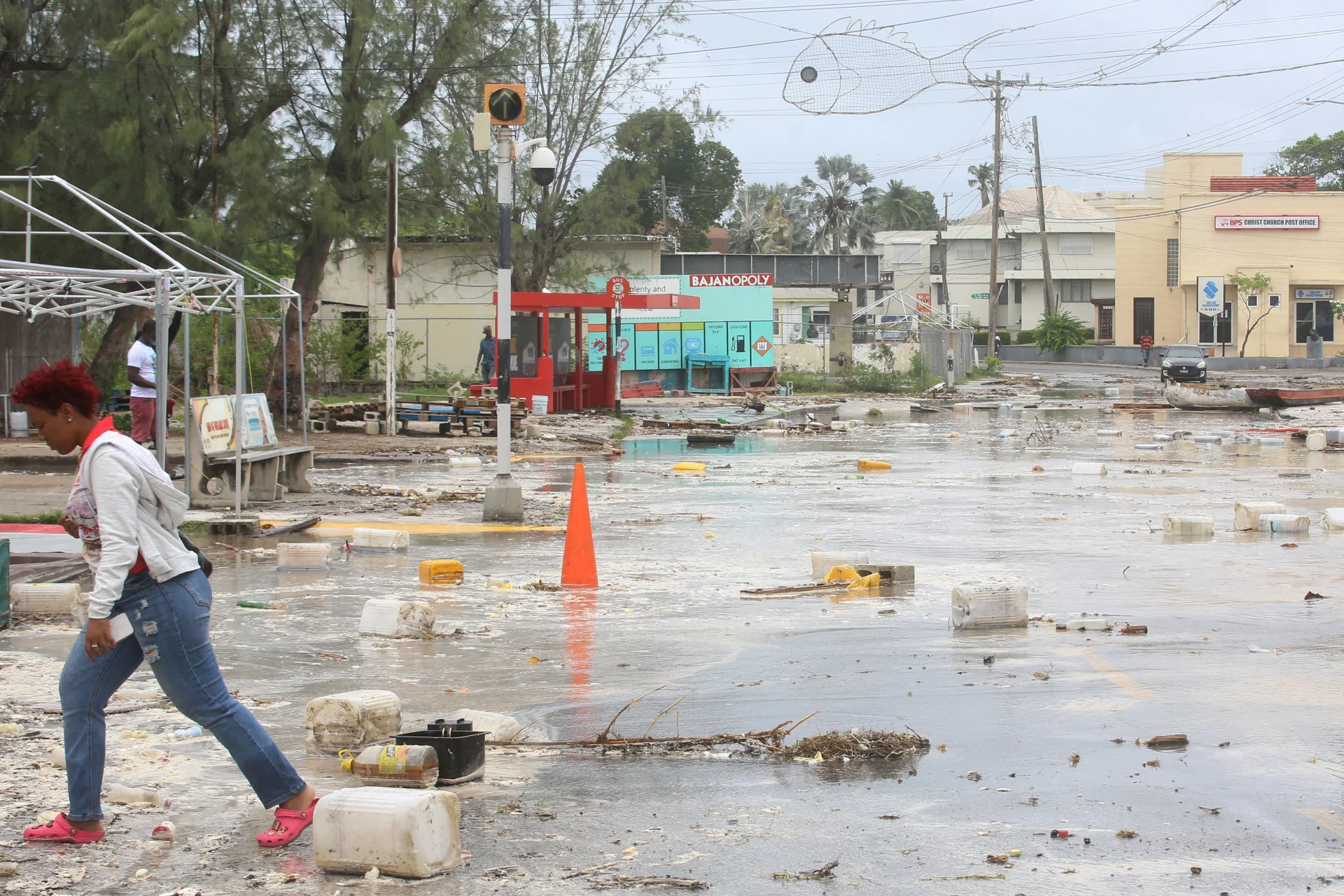 REUTERS: A woman walks through a debris filled street in the Hastings neighborhood after Hurricane Beryl passed in Bridgetown, Barbados July 1, 2024. REUTERS/Nigel R Browne/File Photo