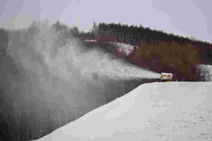 REUTERS: FILE PHOTO: A TechnoAlpin snow gun sprays snow onto a slope for recreational use at the Genting ski resort in Zhangjiakou near venues of the Beijing 2022 Winter Olympics, Hebei province, China, November 20, 2021. REUTERS/Thomas Peter/File Photo