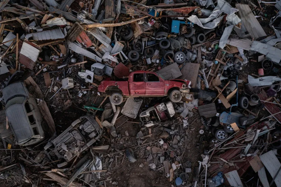 REUTERS: A vehicle lies on its side in a business lot after a tornado devastated Mayfield, Kentucky, U.S. December 13, 2021. Picture taken with a drone. REUTERS/Adrees Latif