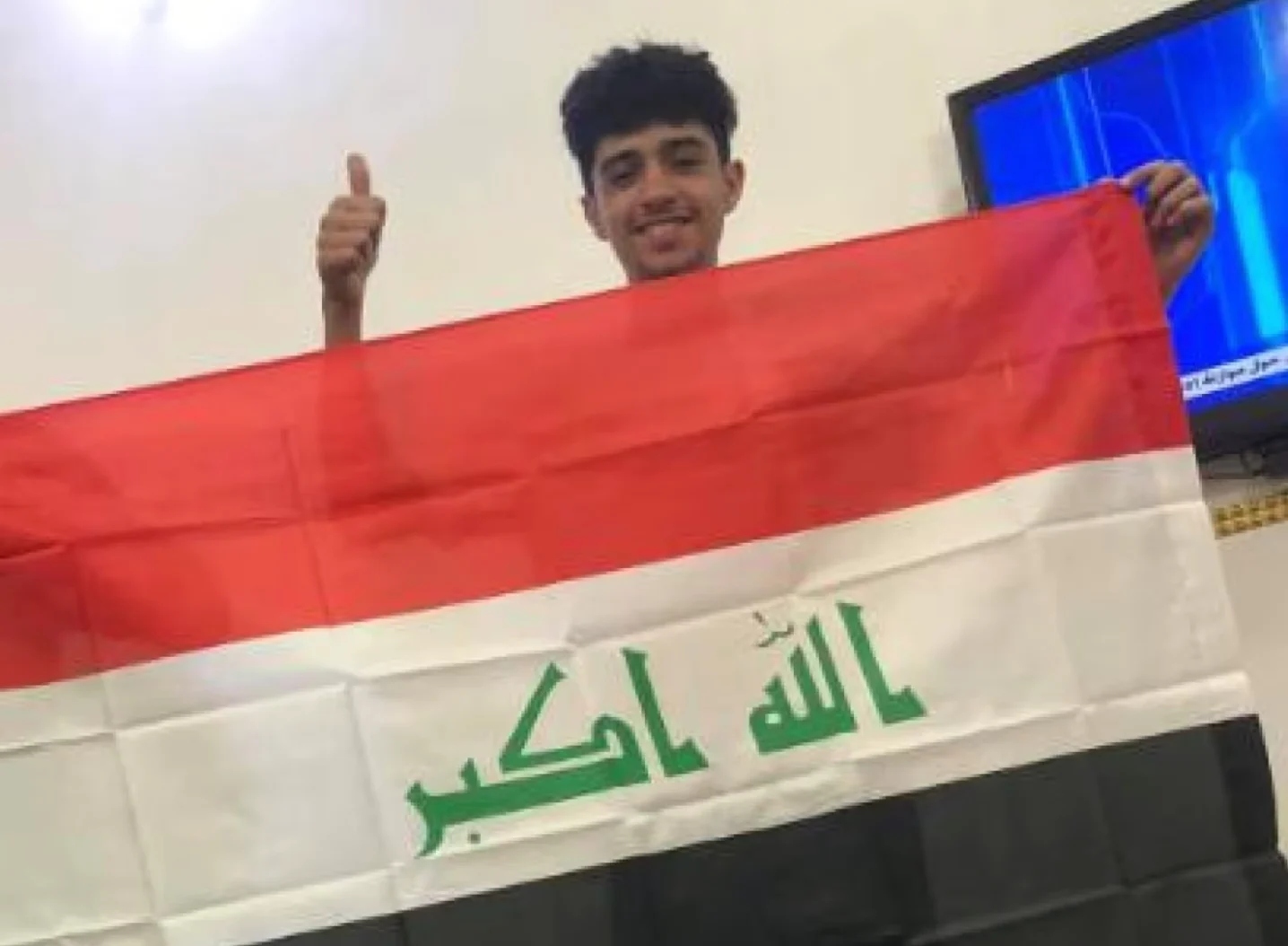 CBC: Ahmed Ahmed poses with an Iraq flag in a Facebook photo posted in February 2021. (Ahmed Ahmed/Facebook)