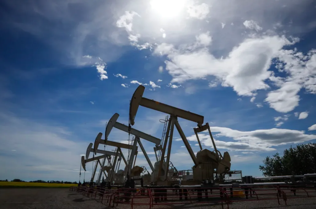 Pumpjacks draw oil out of the ground near Olds, Alta., on July 16, 2020. (Jeff McIntosh/The Canadian Press)
