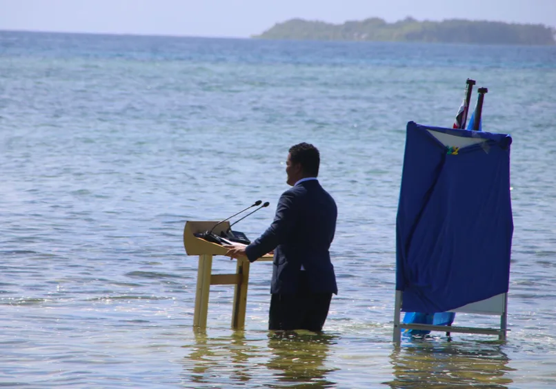 "We are sinking": Tuvalu minister gives climate speech knee-deep in the sea