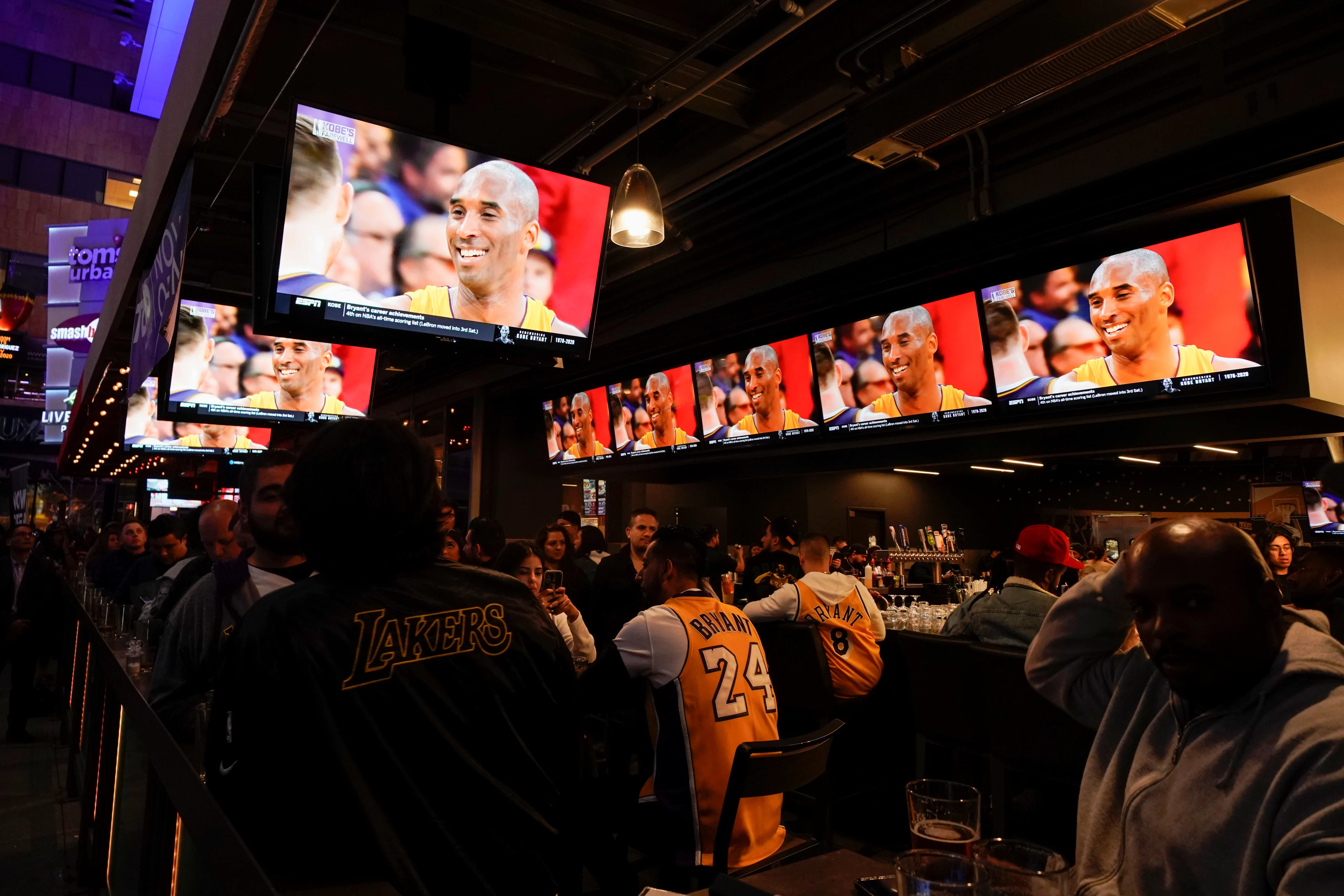 Reuters- Fans of NBA basketball star Kobe Bryant watch a replay of his last NBA game 