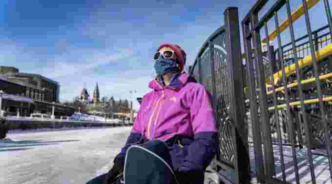CBC: A Rideau Canal Skateway user sits on a bench near its northern end last February. (Brian Morris/CBC)
