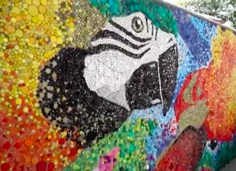 Artist uses 200,000 bottle caps to create stunning eco-mural