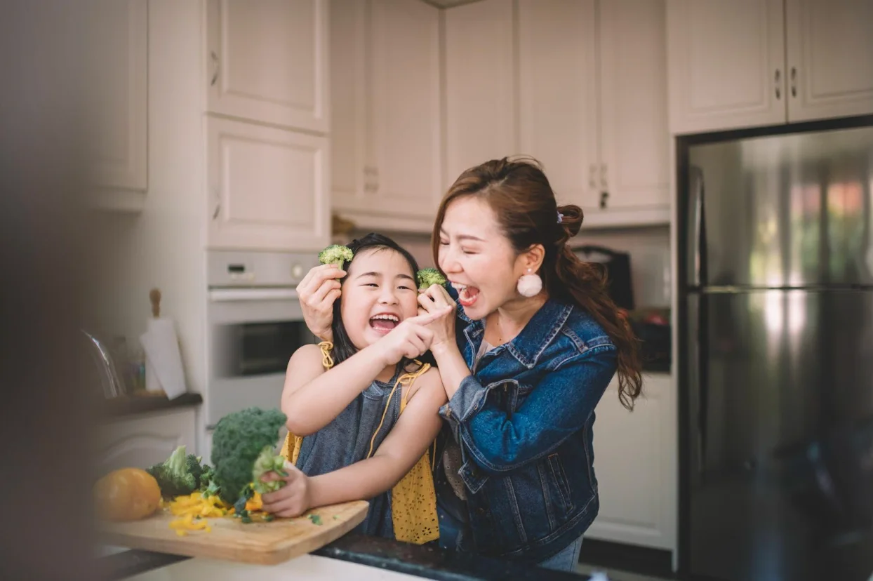 Getty images: Mother daughter laughing in kitchen