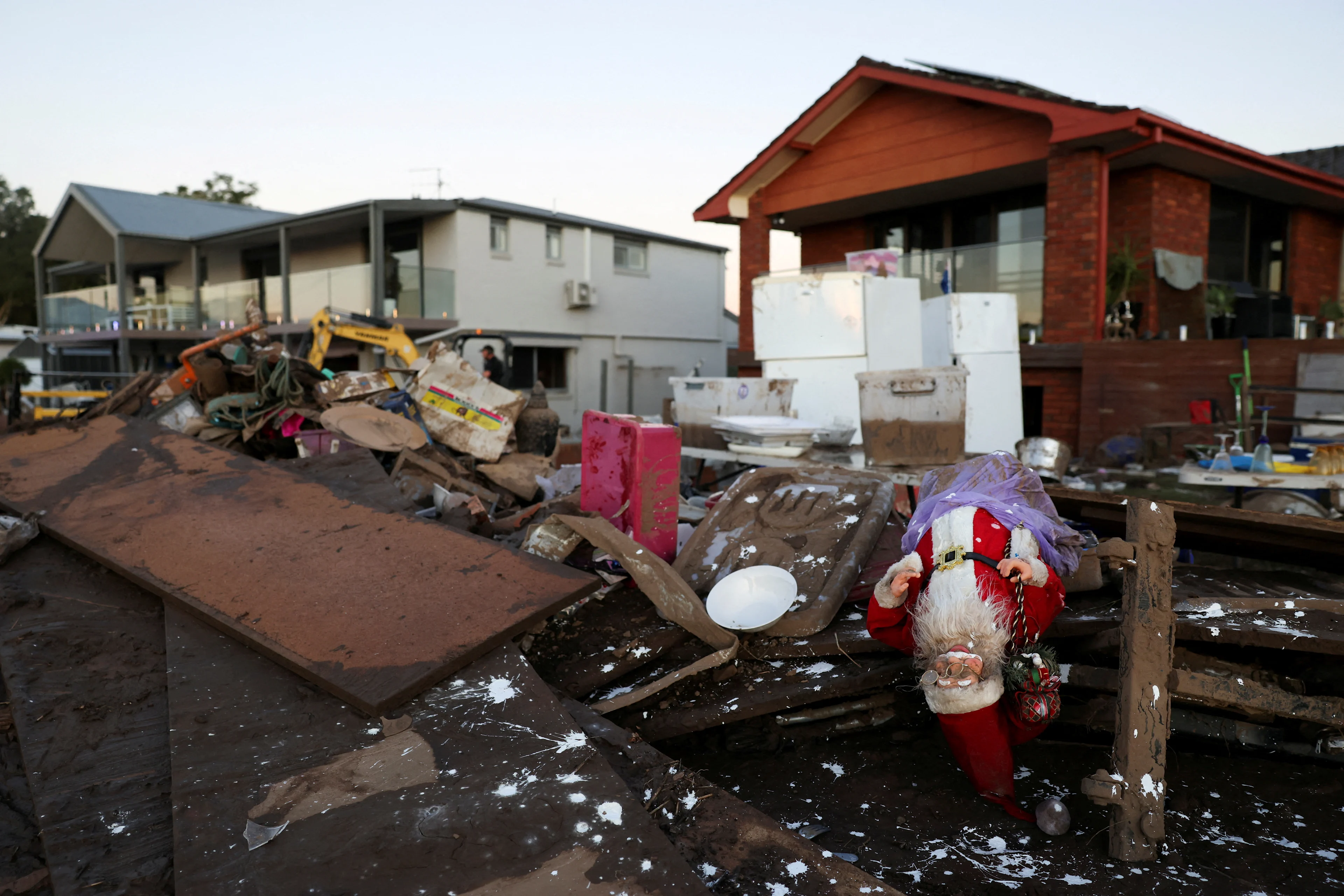 Debris lies outside residential properties affected bt floods next to the Manning River in Glenthorne, Australia, May 24, 2025. REUTERS/Hollie Adams