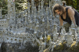 Swiss artist sculpts sprawling model castle on dried riverbank