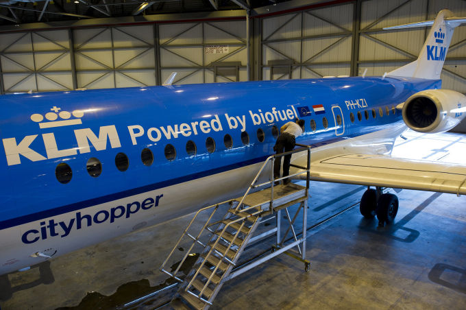 A worker prepares the KLM Fokker 70 cityhopper airplane before its first flight using biofuel, in Schiphol, on August 31, 2011. (Marcel Antonisse/ AFP/ Getty Images)
