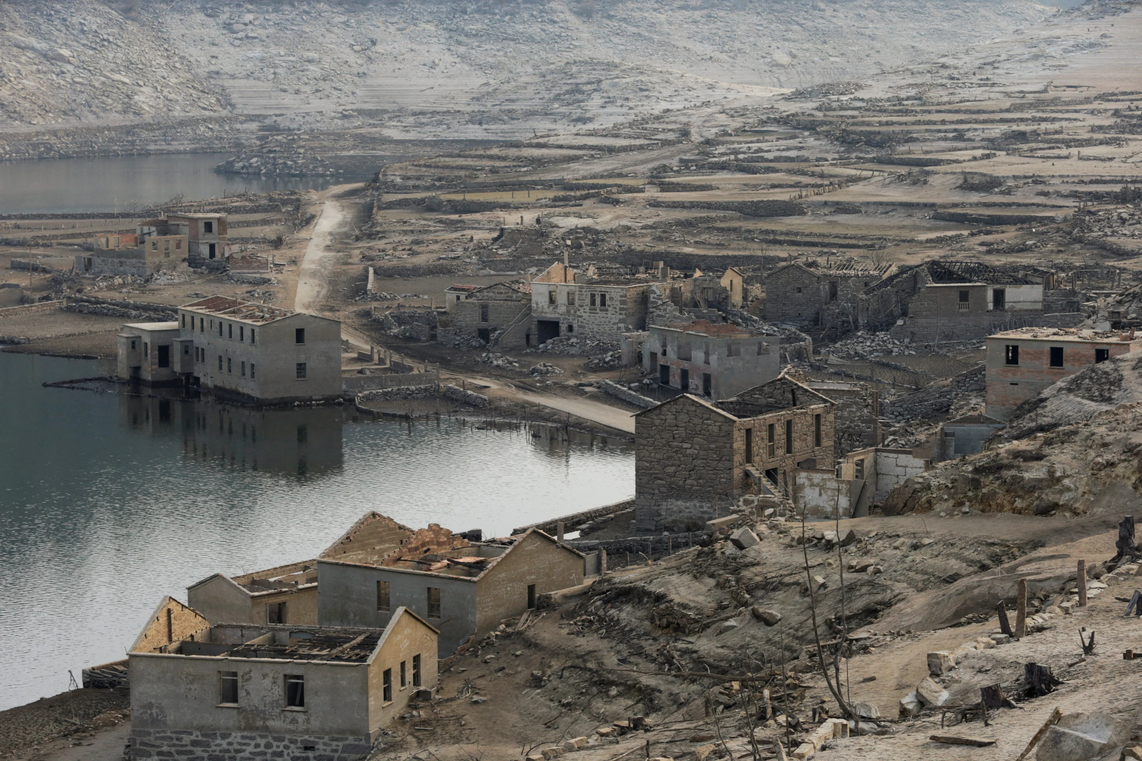 REUTERS: A general view shows the ancient village of Aceredo that had been submerged by Limia river in the 1990s after the dam was built in Concello de Lobios, Spain, February 10, 2022. REUTERS/Miguel Vidal