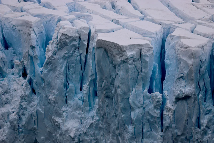 the conversaiton - Ice breaks off the front of a glacier in Antarctica. 66 North via Unsplash