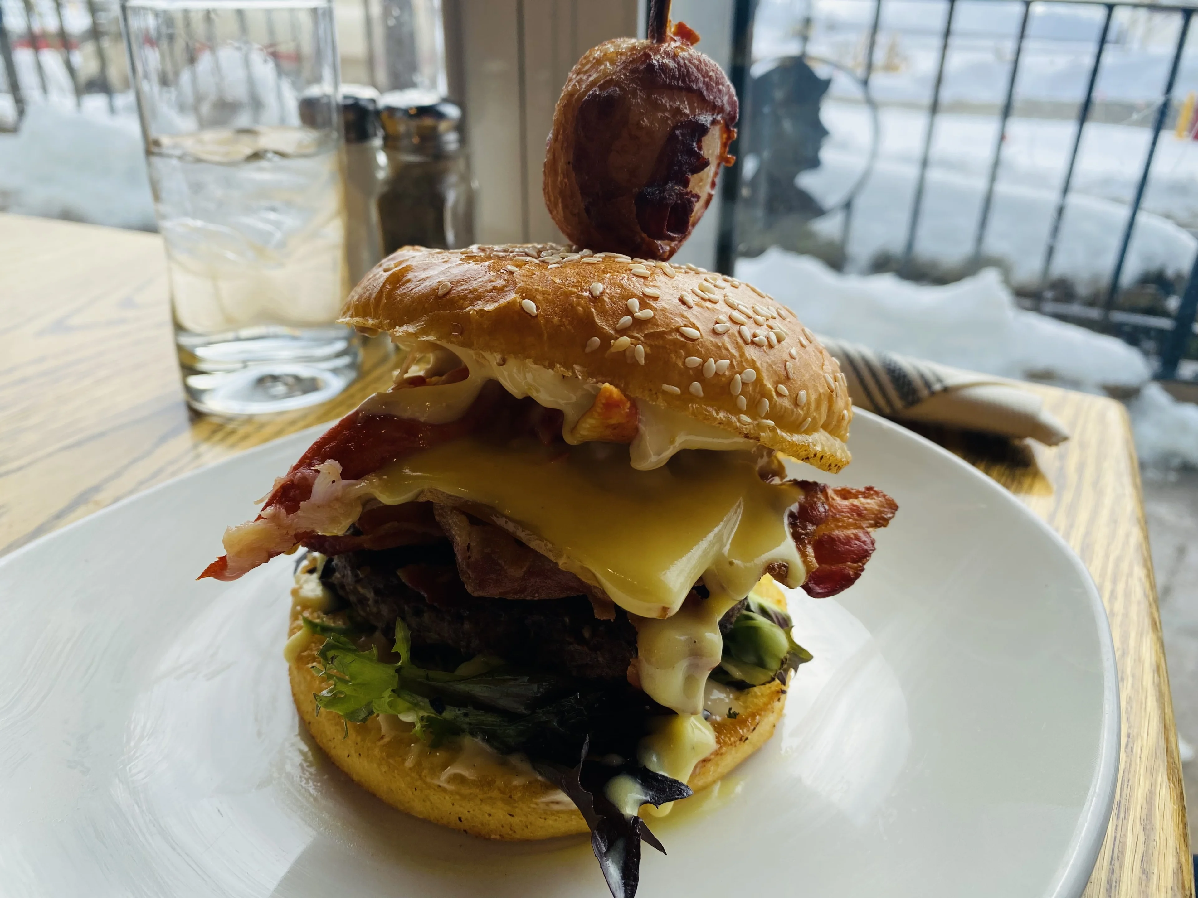 Lunenburger: Six ounces of hand formed fresh local ground beef, smoked mozzarella, smoked bacon, arugula, garlic aioli, generously topped with NS lobster, all knuckle & claw meat, and a tarragon butter