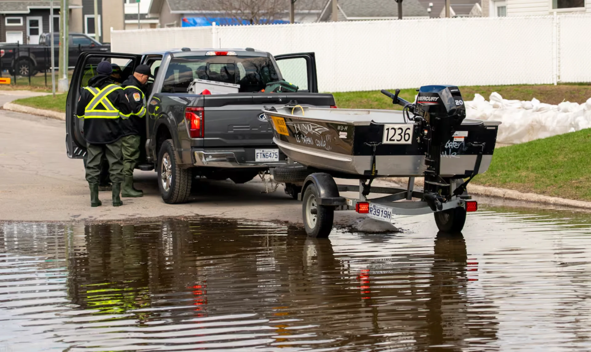 CBC: Gatineau, Que., firefighters work near one of their boats in an area near the Ottawa River on April 21, 2026. (Jason MacLellan/CBC)