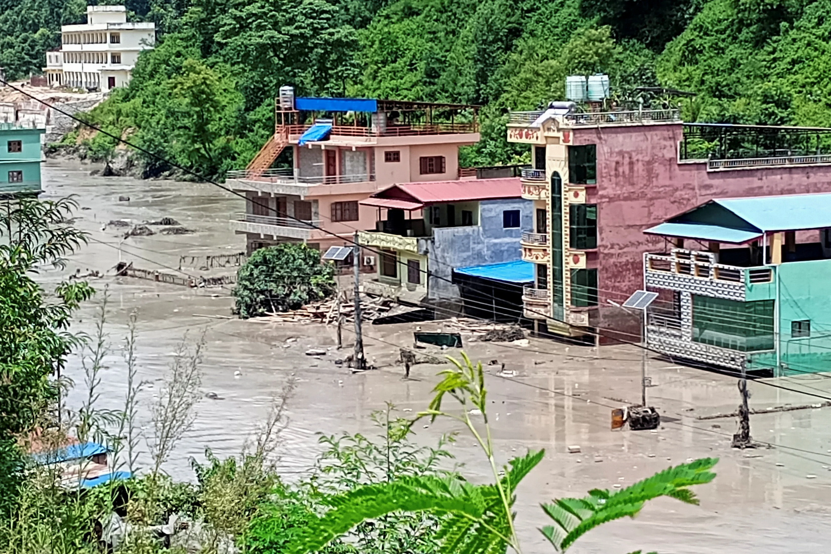 A flooded road following a flash flood in Galchhi in the Dhading district, Nepal, August 26, 2026. Picture taken with a mobile phone - REUTERS - Stringer