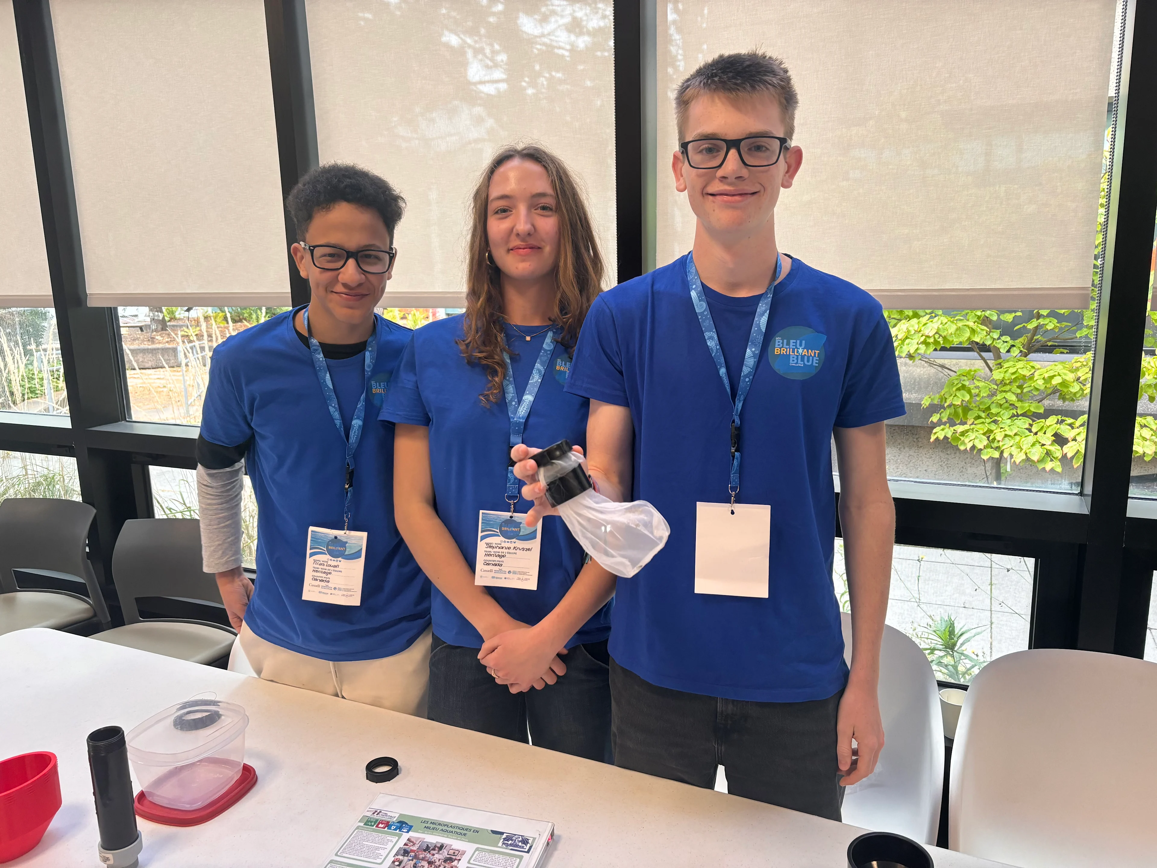 Three students from Cornwall, Ont., with their microplastics filter made from recycled plastic bottles. (Nate Coleman/TWN)